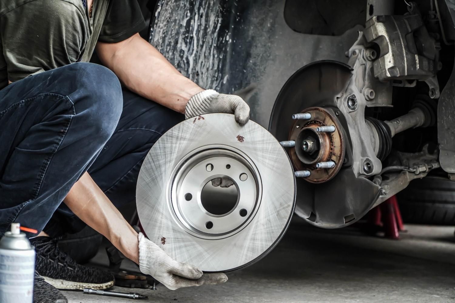A Mechanic Holding a New Brake Rotor — BEB Automotive In Sutherland, NSW
