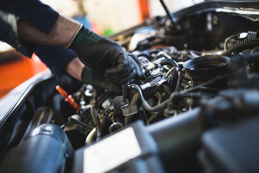 A Mechanic Working on A Car Engine — BEB Automotive In Caringbah, NSW