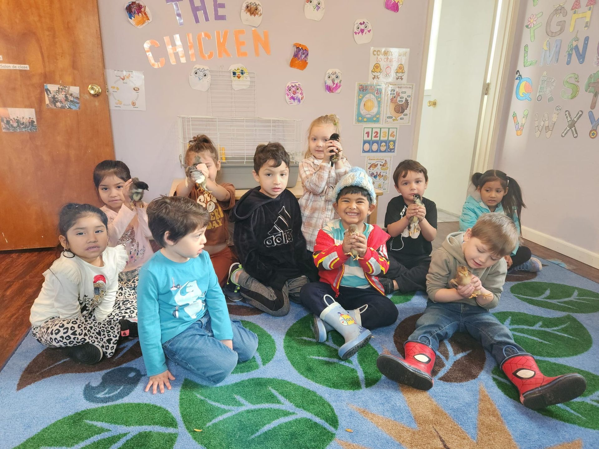 A group of children are sitting on the floor in a room.