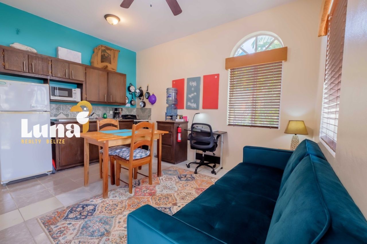 A kitchen with a table and chairs and a rug
