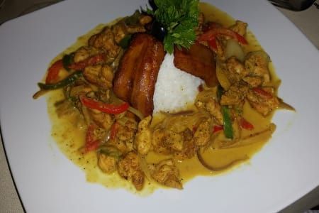 A plate of food with rice and vegetables on a table