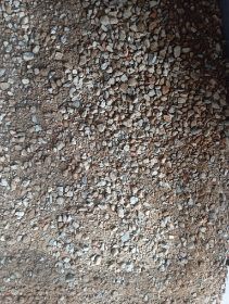 Gravel and small stones covering a dirt surface.