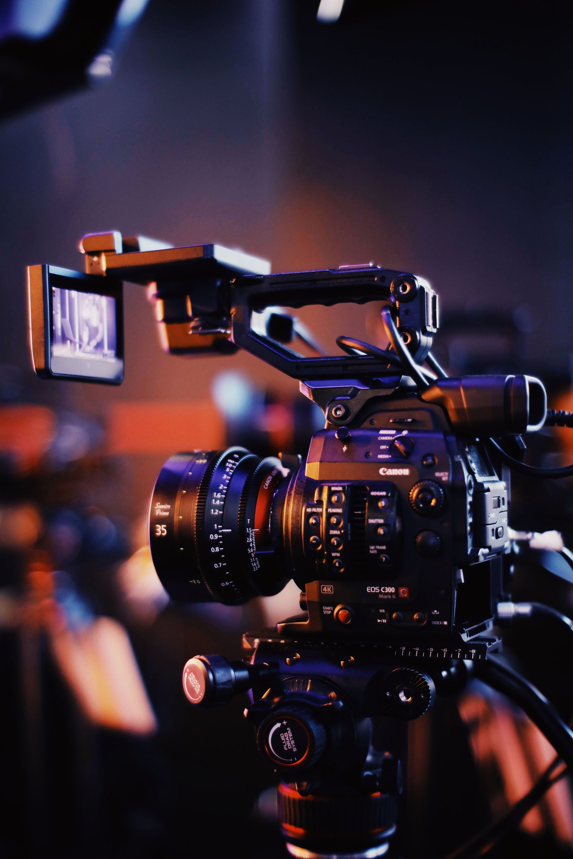 Professional video camera with flip-out monitor in a dimly lit studio setting on a video shoot with Wilsona Marketing