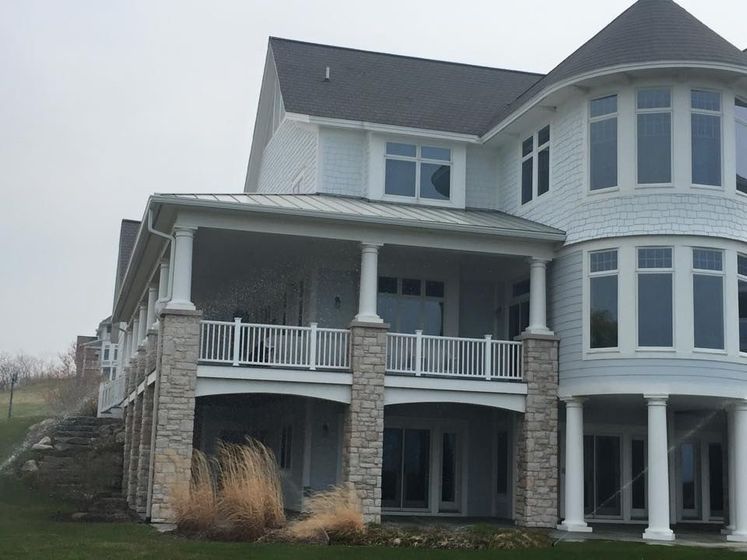 A large white house with a lot of windows and a porch