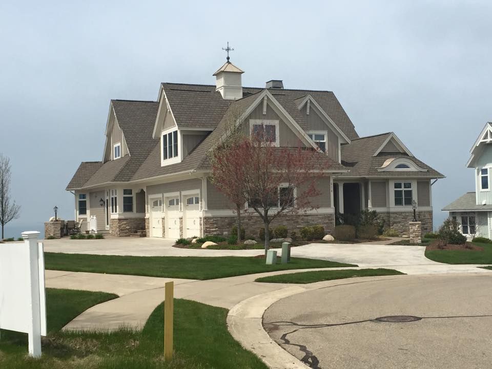 A large house with a white sign in front of it