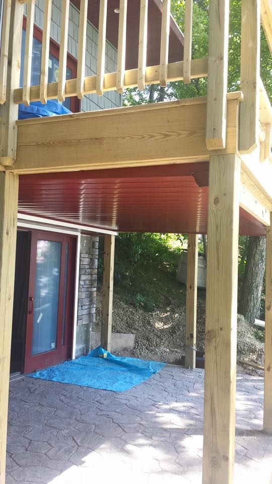 A wooden deck is being built underneath a house.