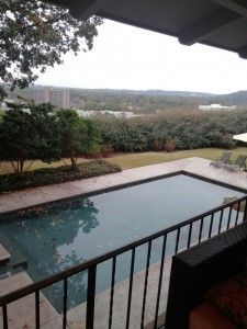 A view of a large swimming pool from a balcony.