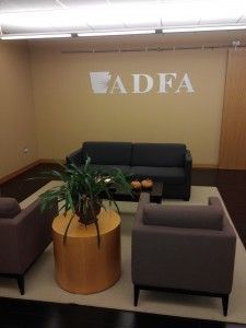 A living room with a couch and chairs and a sign that says adfa