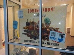A window with a sign that says coming soon on it