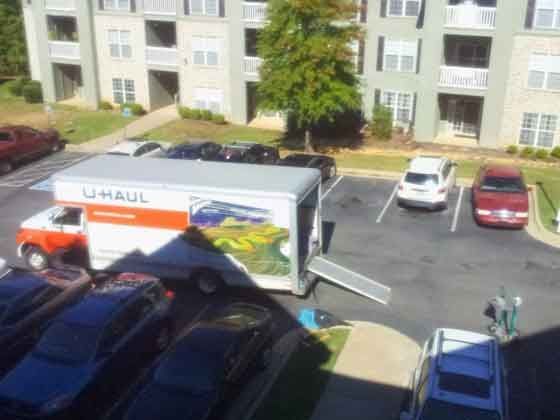 A u-haul truck is parked in a parking lot