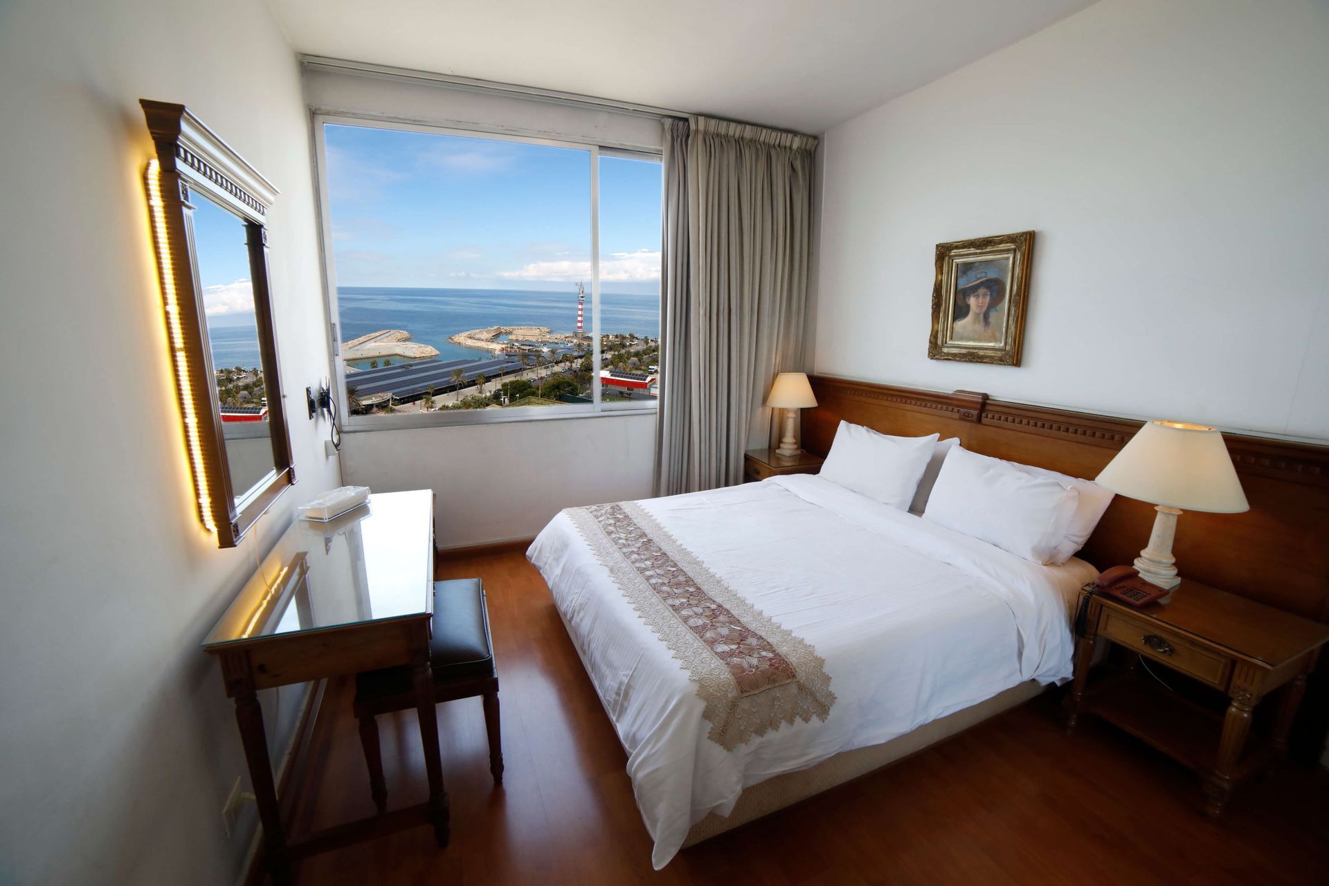 A hotel room with a large bed and a large window