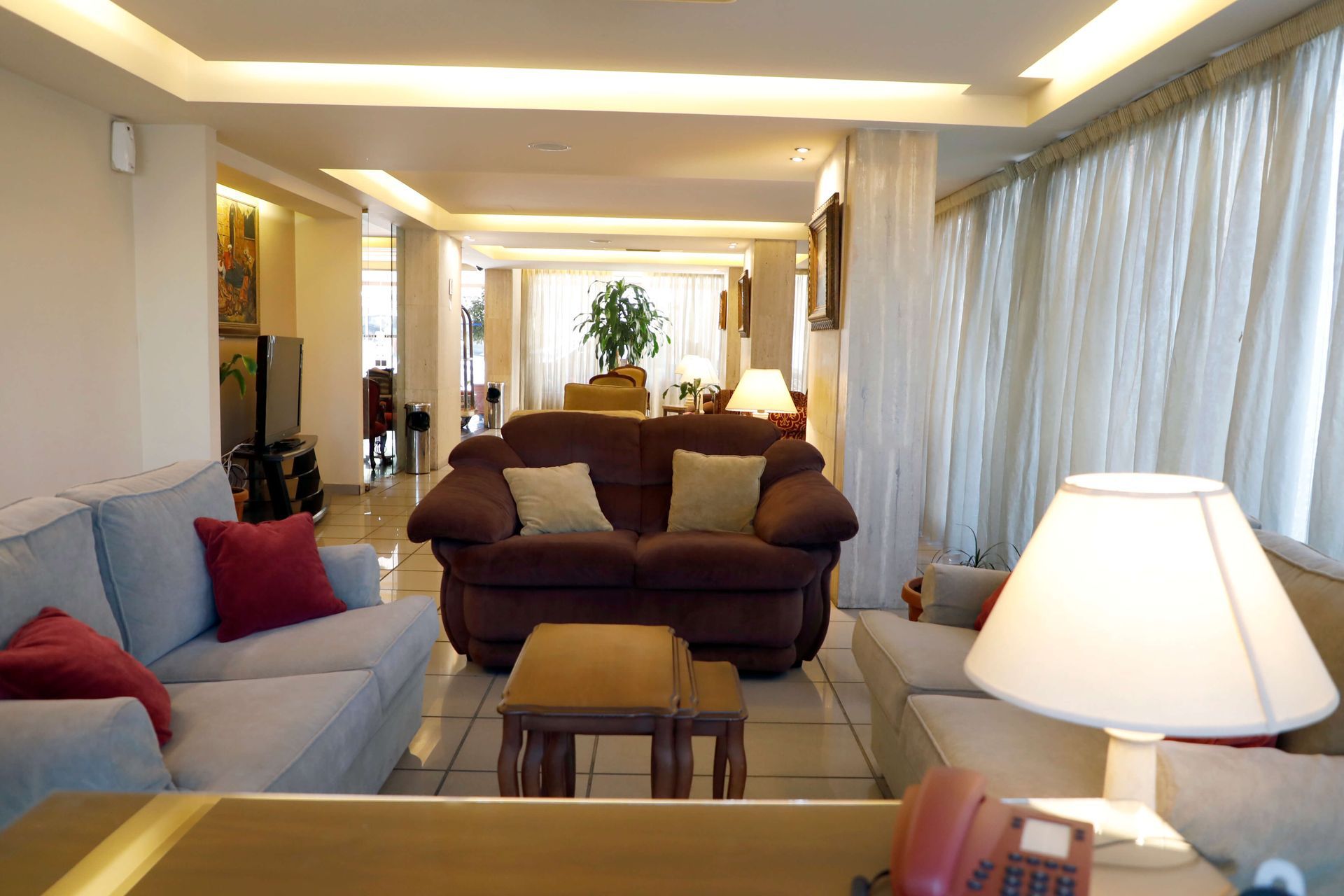A living room with a couch and a lamp