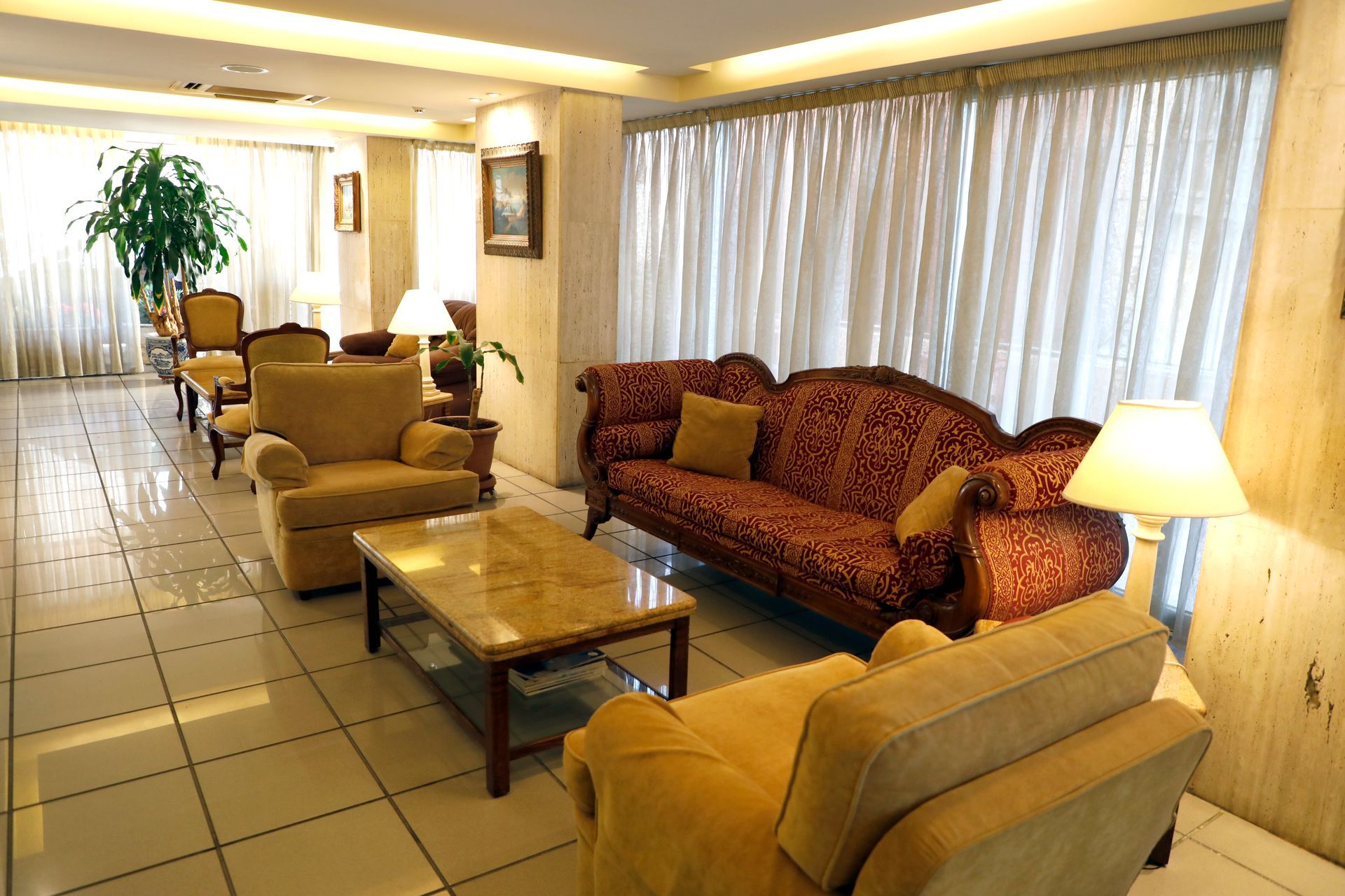 A living room with a couch and chairs and a coffee table