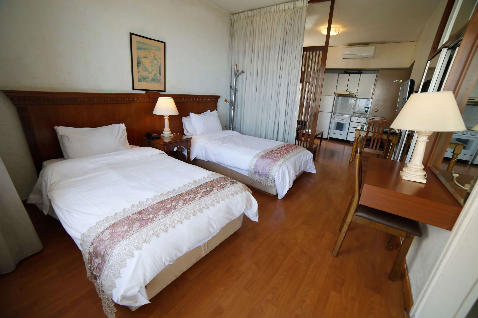 A hotel room with two beds and a desk