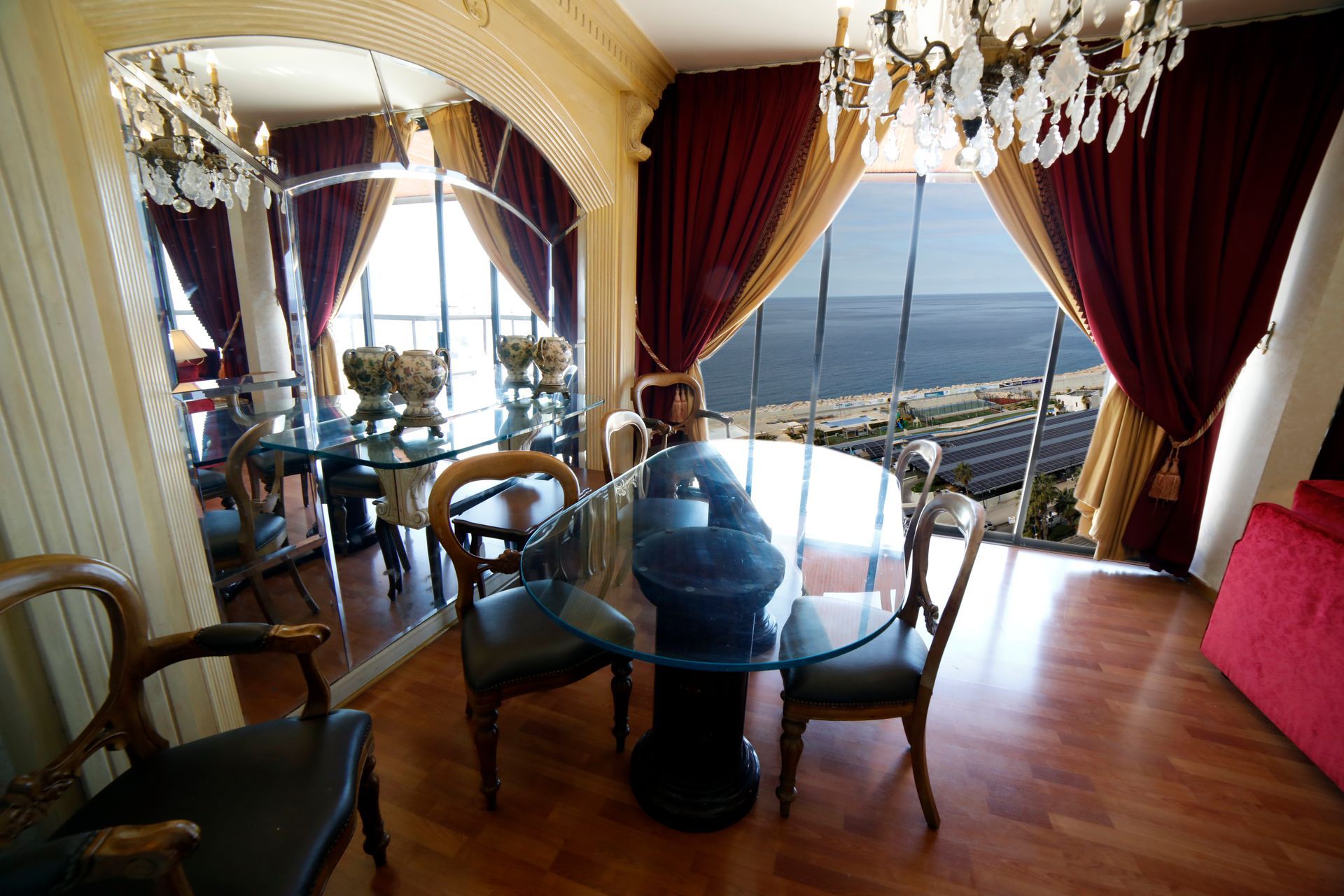 A dining room with a glass table and chairs