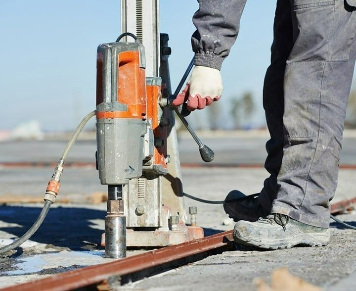 A Worker Using a Core Drill to Bore a Hole in Concrete — McGrath Electrical & Data in South Grafton, NSW