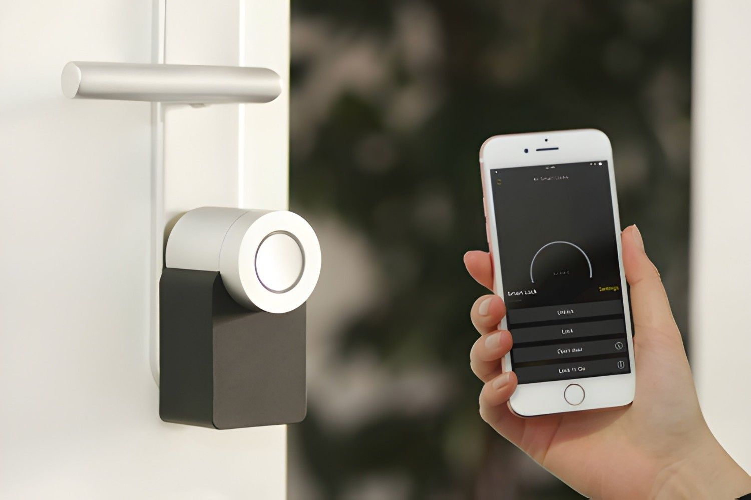A Hand Holds a Smartphone, Interacting With a Smart Lock on a White Door — McGrath Electrical & Data in South Grafton, NSW