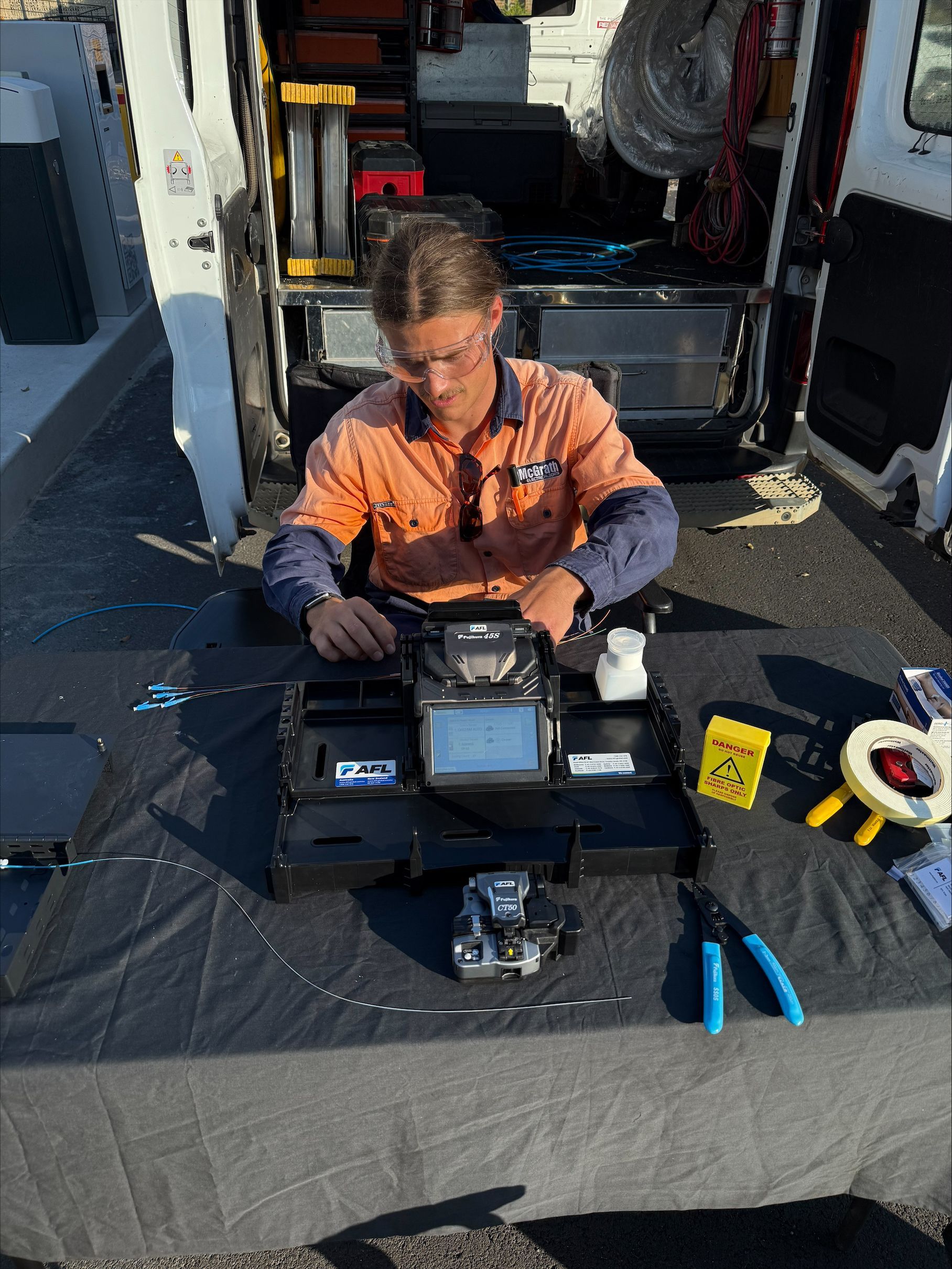 A Electrican is working on a large outdoor system — McGrath Electrical & Data in Maclean, NSW
