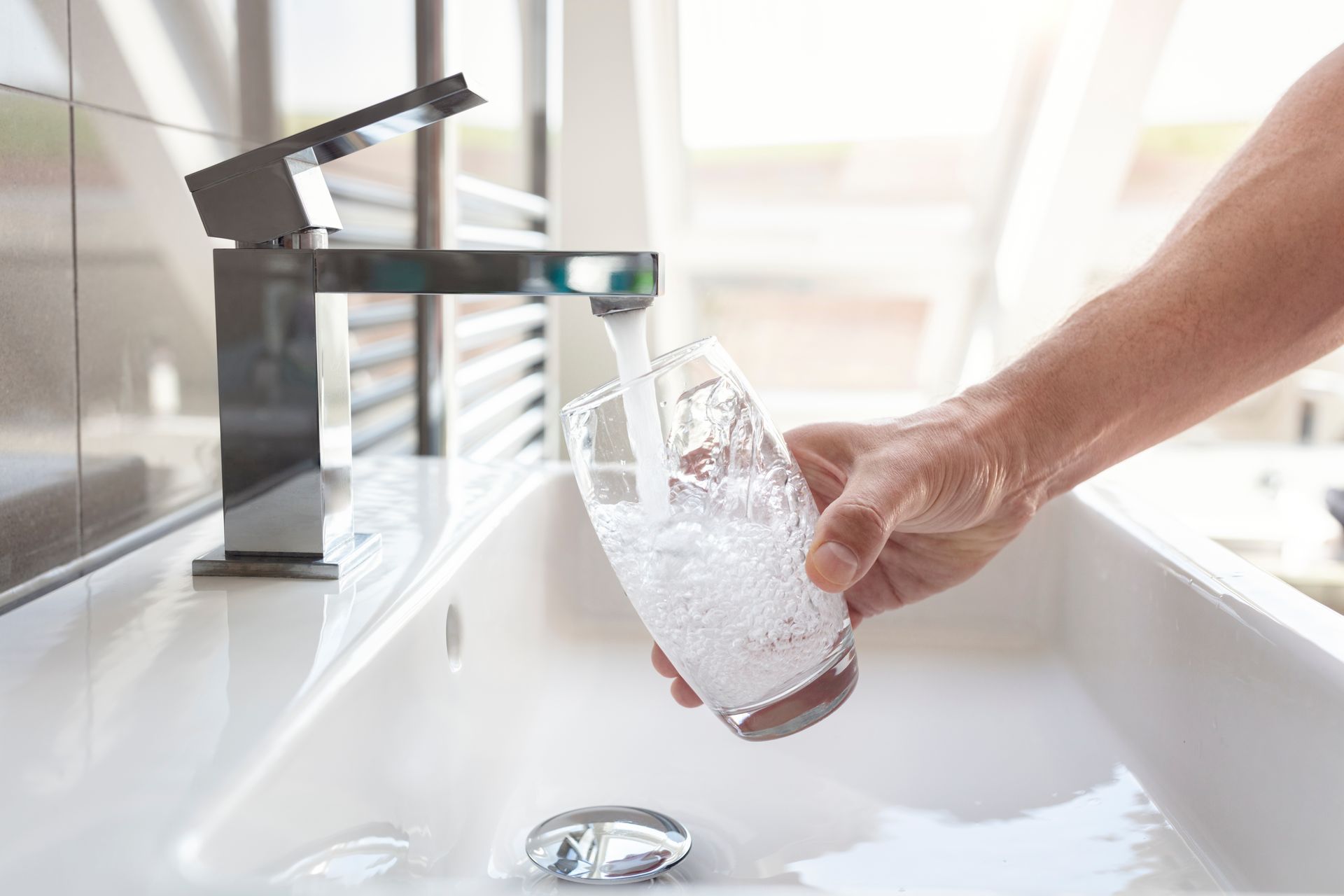 Water being poured into a class after being treated