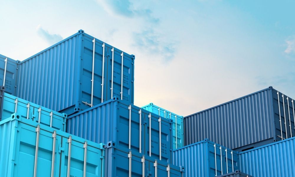 blue shipping containers stacked on top of each other