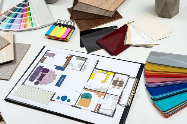 Crea una mood board con campioni di tessuto, campioni di colore, elementi in legno e un quaderno di schizzi di stile su un tavolo.
