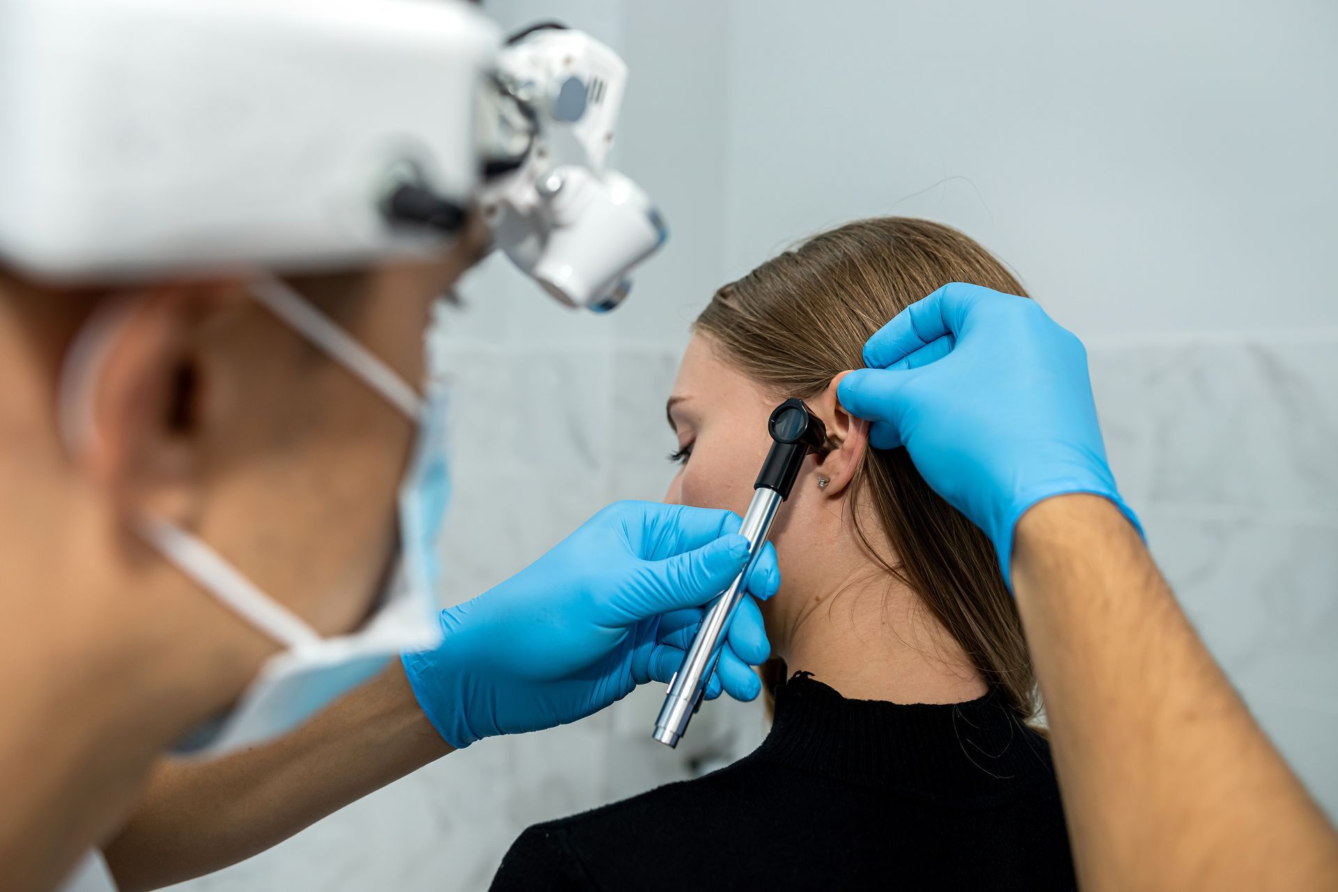 woman getting an ear exam at ENT office