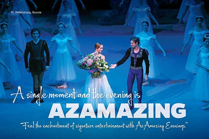 Blue-lit stage with performers and the text “A single moment and the evening is AZAMAZING”