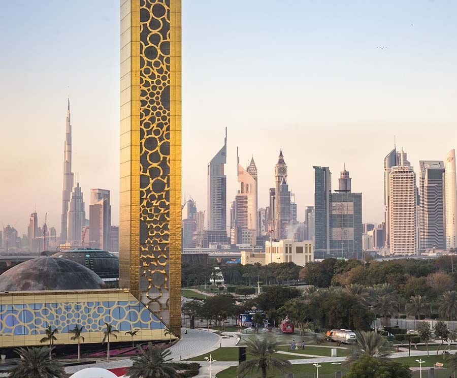 Dubai skyline at sunset, framed by the gold-patterned Museum of the Future in the foreground