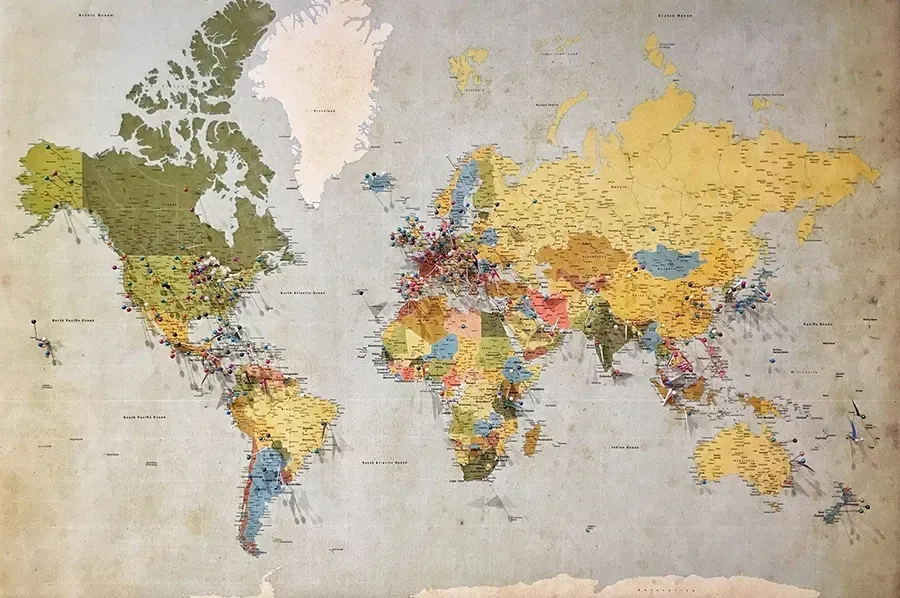 Colorful world map wall art with countries in varied colors on a light background