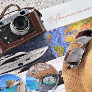 Travel collage with camera, map, sunglasses, hat, boat, and beach photos on a passport-themed background