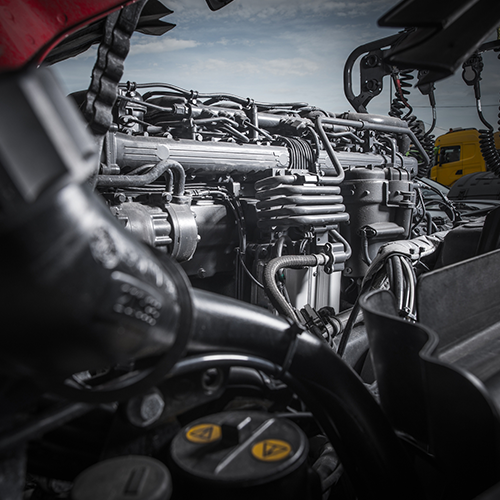A close up of a truck engine with the hood open