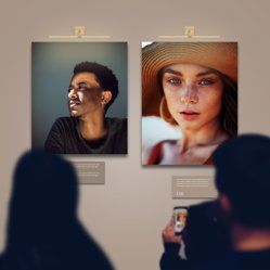 people looking at mounted prints on the wall