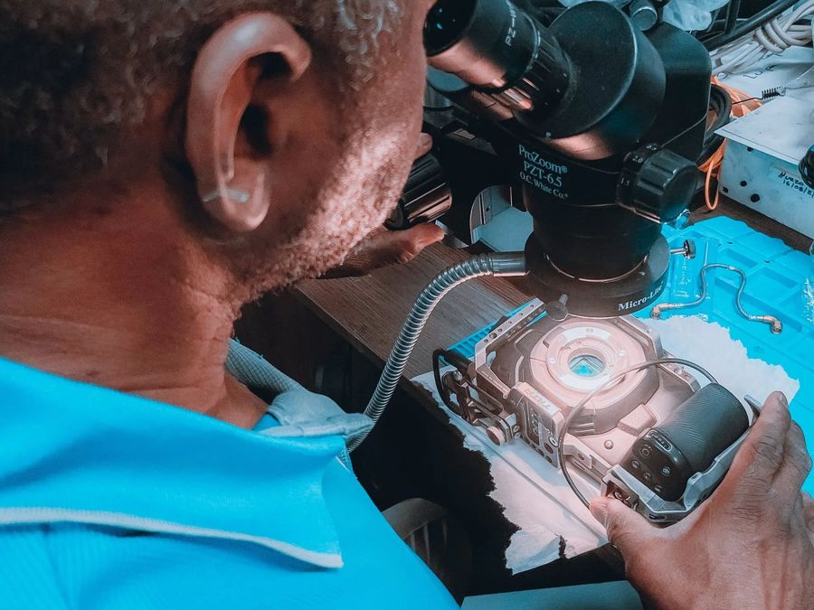a man looking through a microscope