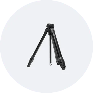 a black tripod is sitting on top of a white circle .