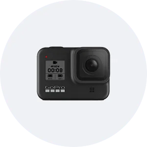 a gopro hero 8 black action camera is sitting on top of a white circle .