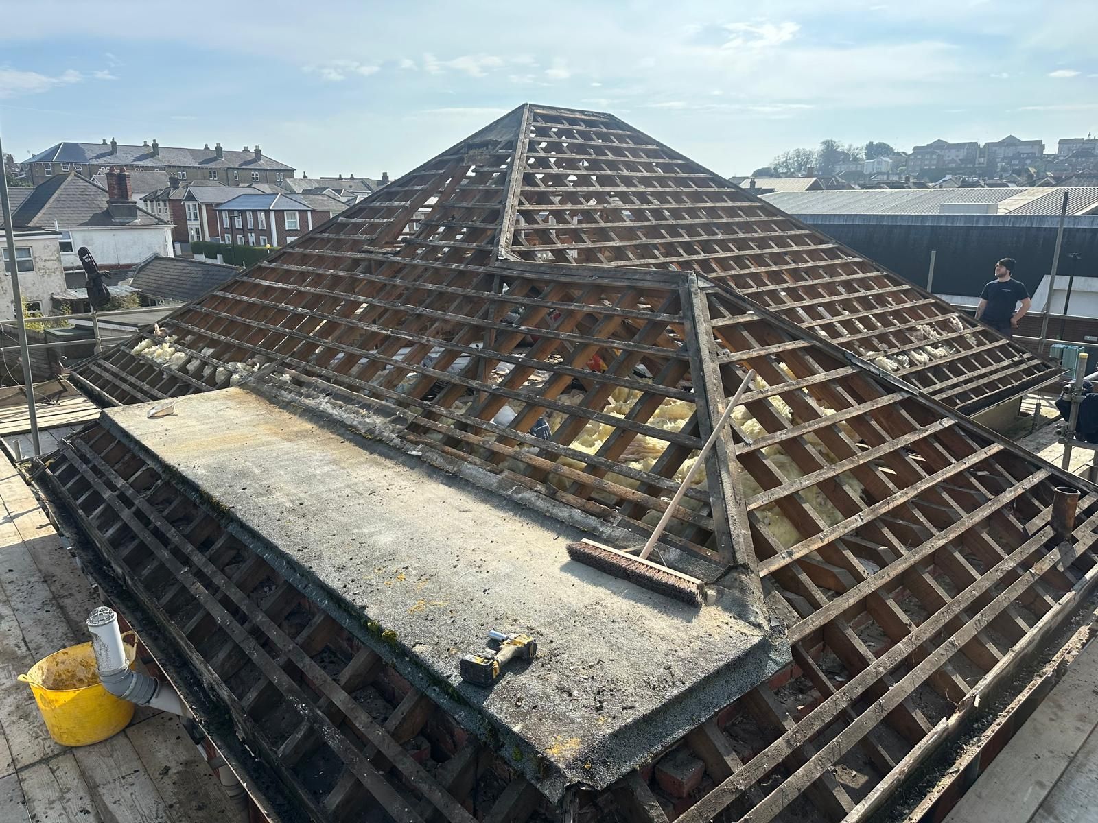 The roof of a building is being demolished.
