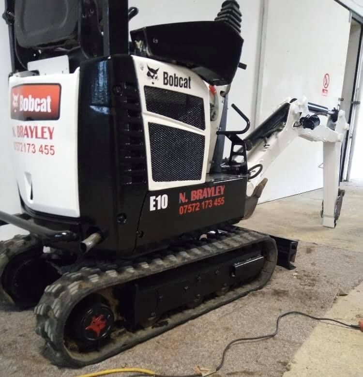 A bobcat e10 is parked in a garage