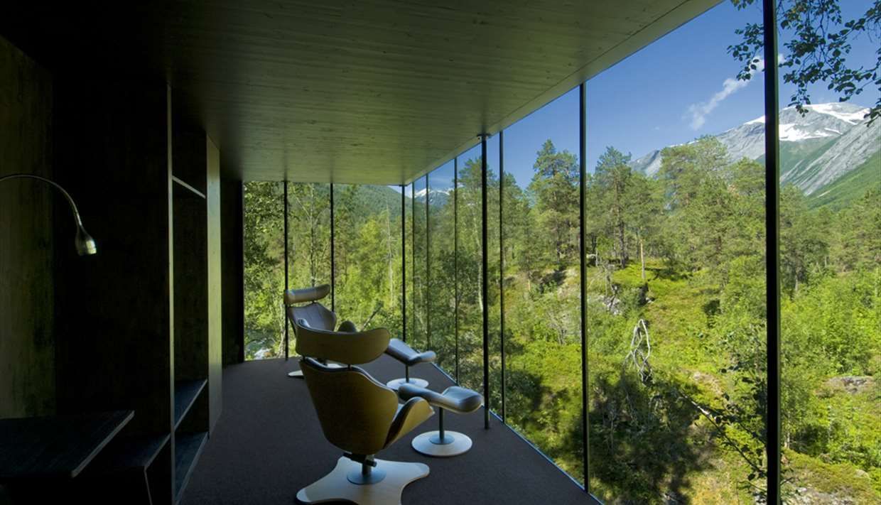En stue med utsikt over skog og fjell