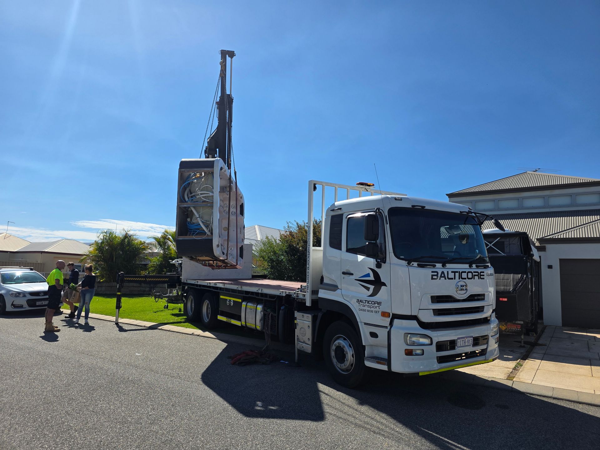Balticore Hiab crane truck lifting a spa on a Perth residential street