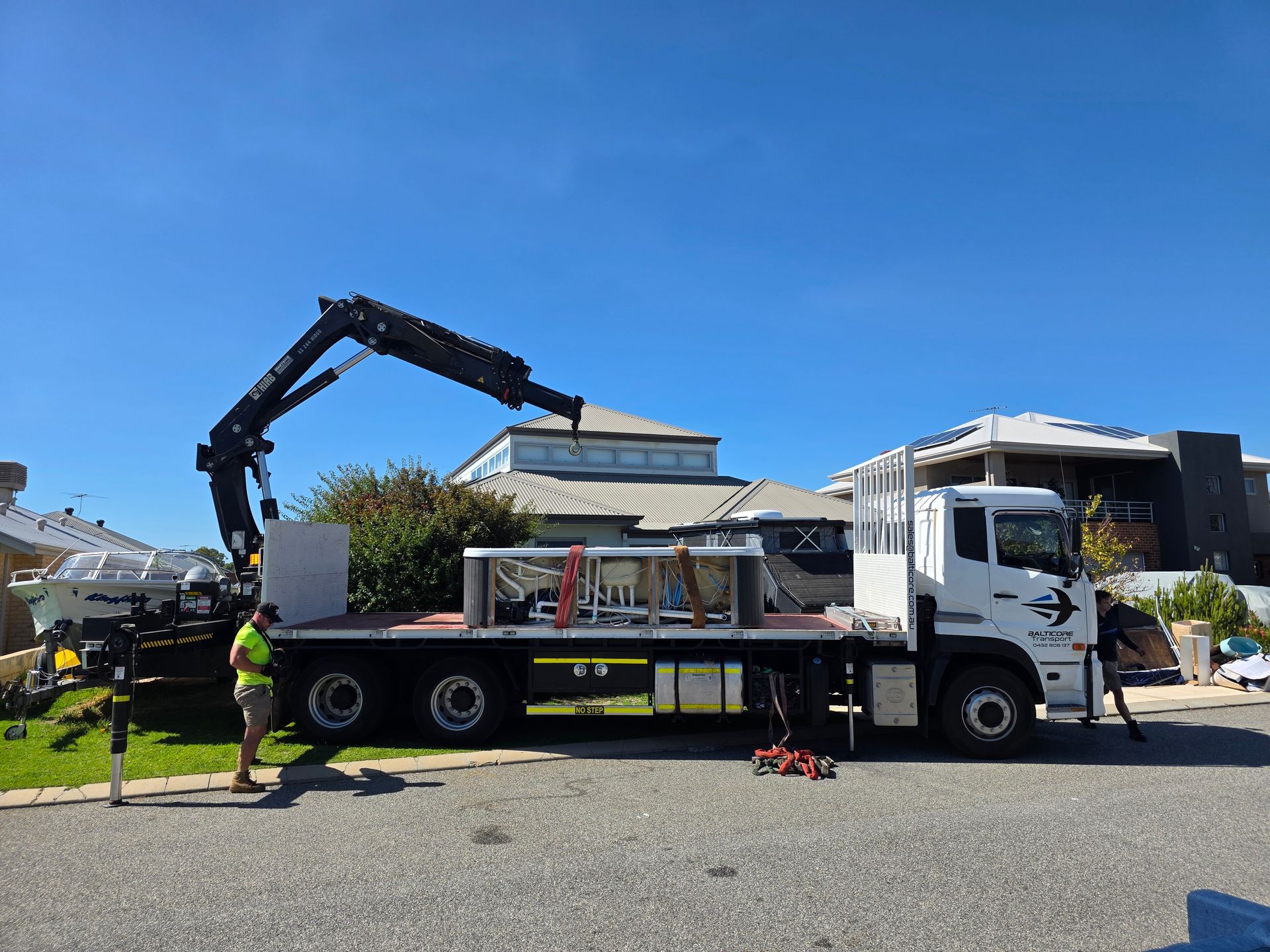 Spa strapped on a Balticore Hiab tray on a Perth street