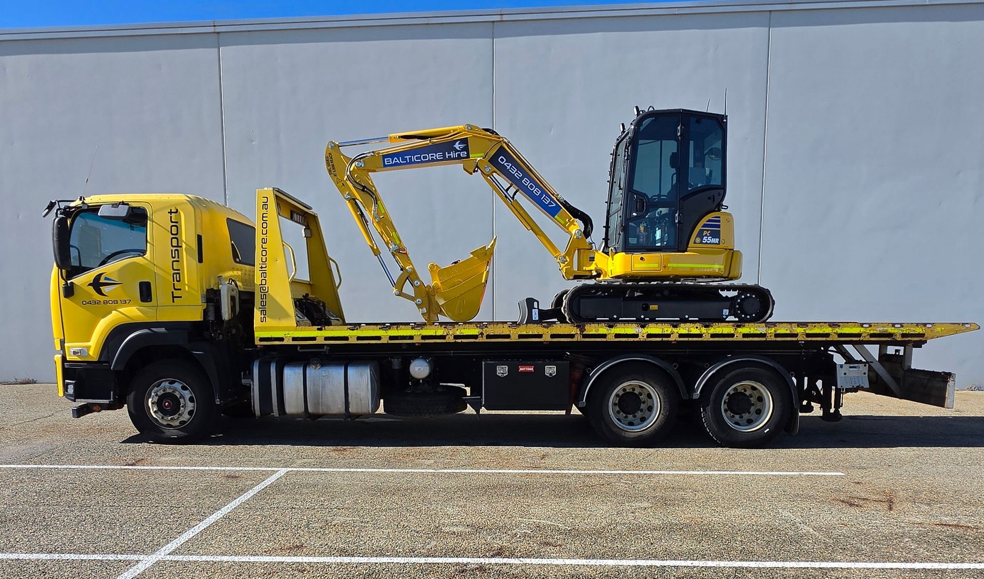 Komatsu excavator on Balticore tilt tray truck for plant transport Perth