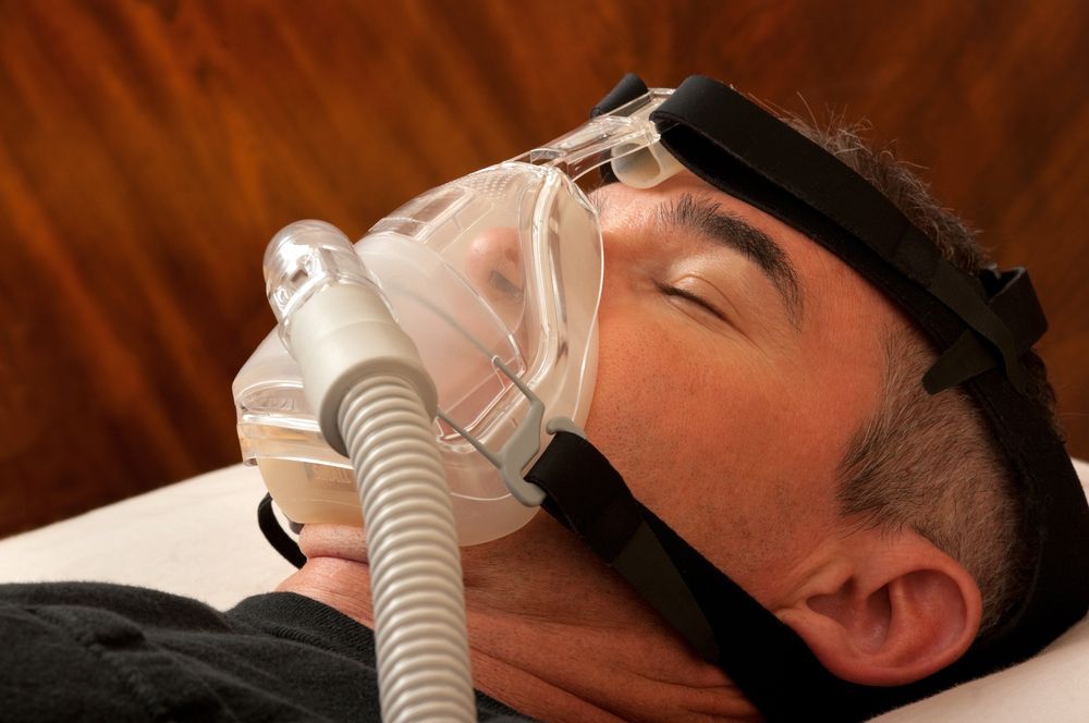Person Lying on Their Back Wearing a Cpap Mask — Killara Dental in East Killara, NSW