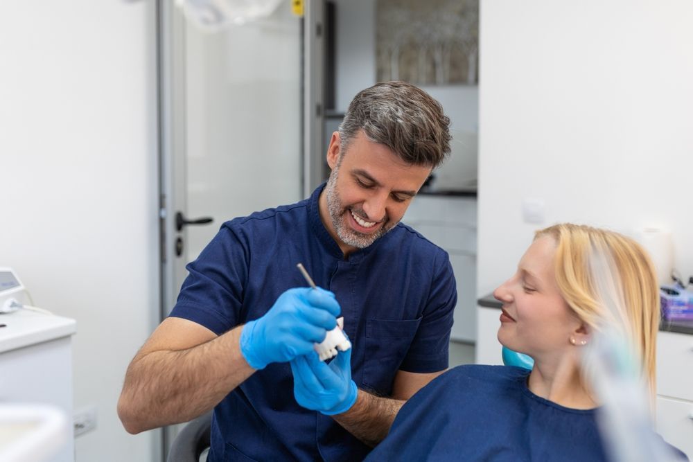 Dentist Wearing Blue Scrubs and Gloves — Killara Dental in East Killara, NSW