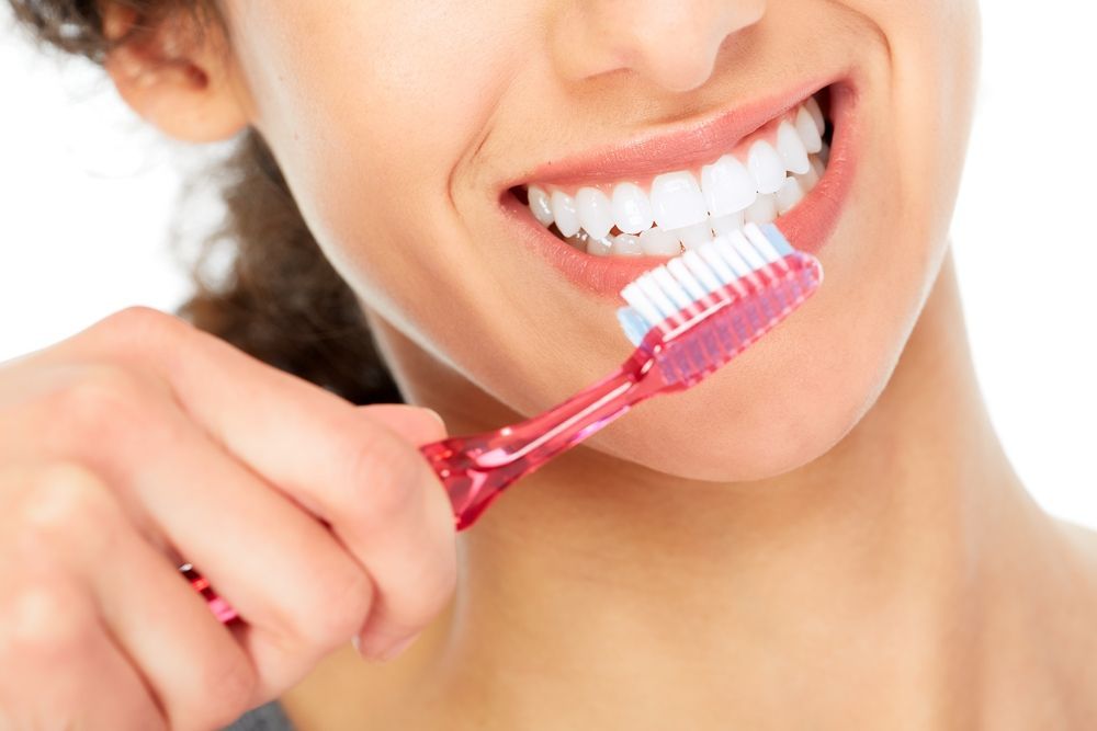 Person Smiling While Brushing Their Teeth — Killara Dental in East Killara, NSW
