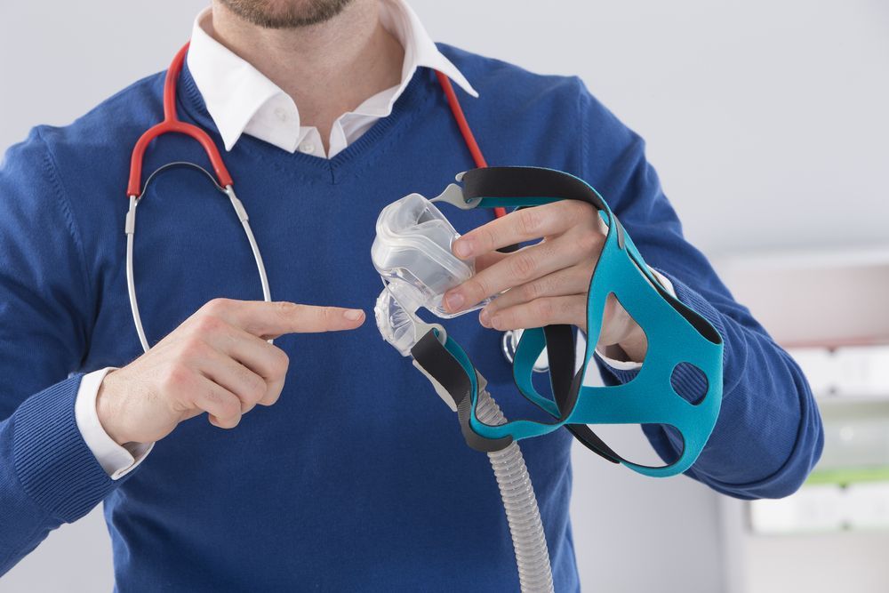 Medical Professional Points to a Cpap Nasal Mask — Killara Dental in East Killara, NSW