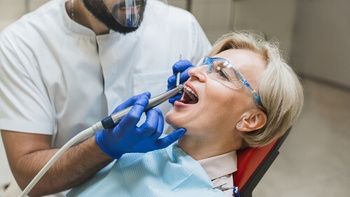 A Dentist Wearing a Protective Mask and Blue Gloves — Killara Dental in East Killara, NSW