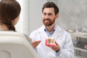 A Dentist in a White Coat Explains a Dental Procedure — Killara Dental in East Killara, NSW