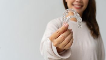 A Person in a Light-coloured Shirt Smiles — Killara Dental in East Killara, NSW