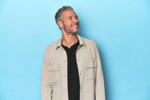 A Smiling Man Wearing a Beige Overshirt and Black Shirt — Killara Dental in East Killara, NSW