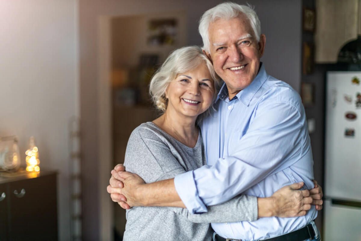 Two Smiling People Embracing Warmly — Killara Dental in East Killara, NSW